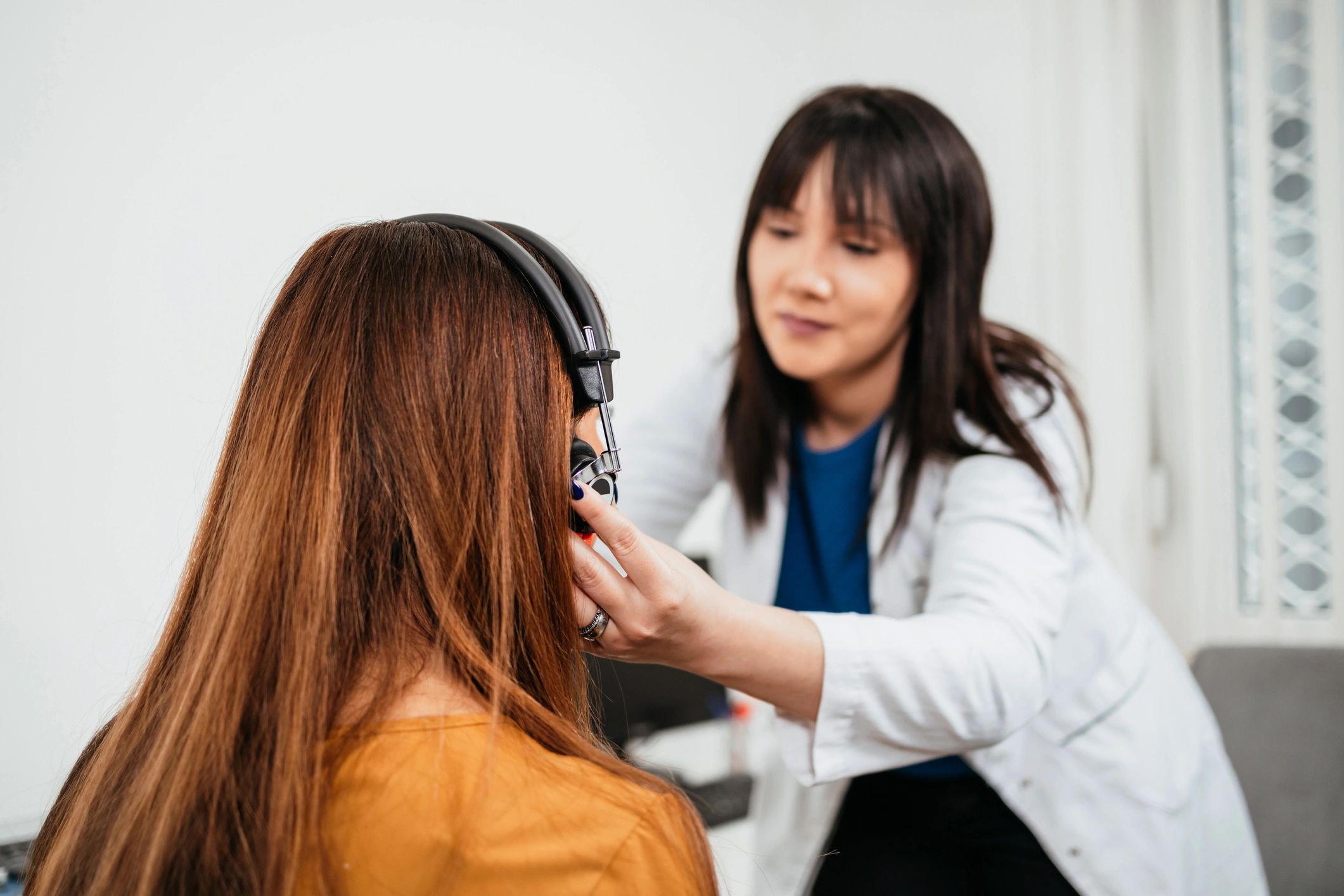 Closeup of a hearing test being conducted with a senior patient